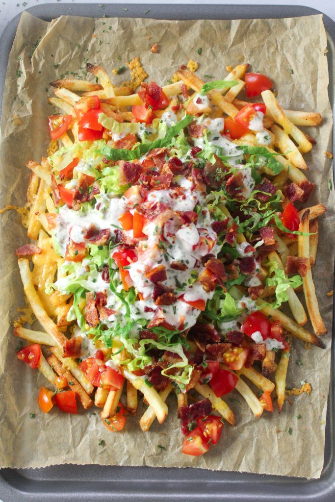 Loaded Ranch fries with cheese, bacon, lettuce, tomato and ranch dressing